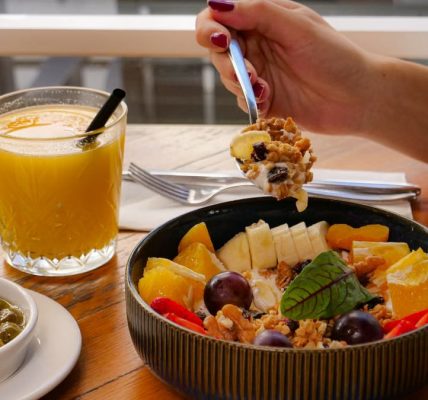 Enjoy a nutritious breakfast with fruit, nuts, and juice in a calm setting in İzmir, Türkiye.