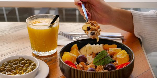 Enjoy a nutritious breakfast with fruit, nuts, and juice in a calm setting in İzmir, Türkiye.